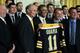 WASHINGTON, DC - JANUARY 23: U.S. President Barack Obama (3rd L) poses for photos with members of the Boston Bruins (first row, L-R) head coach Claude Julien, team owner Jeremy Jacobs, Jacobs' son Charlie, team president of Cam Neely and assistant general manager Jim Benning after he was presented with a jersey by during a East Room event at the White House January 23, 2012 in Washington, DC. The six-time Stanley Cup champions were honored by the President for winning the 2011 Stanley Cup last June. (Photo by Alex Wong/Getty Images)