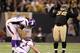 NEW ORLEANS - JANUARY 24: Phil Loadholt #71 of the Minnesota Vikings checks on teammate Brett Favre #4 after he was hit by Remi Ayodele #92 of the New Orleans Saints during the NFC Championship Game at the Louisiana Superdome on January 24, 2010 in New Orleans, Louisiana. (Photo by Ronald Martinez/Getty Images)