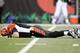 CINCINNATI - JANUARY 08: Quarterback Carson Palmer #9 of the Cincinnati Bengals lays on the ground after being hit in the knee on the first drive of the AFC Wild Card Playoff Game against the Pittsburgh Steelers at Paul Brown Stadium on January 8, 2006 in Cincinnati, Ohio. The Steelers defeated the Bengals 31-17. (Photo by Andy Lyons/Getty Images)