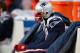 FOXBORO, MA - JANUARY 10: Randy Moss #81 of the New England Patriots sits on the bench dejected late in the fourth quarter against the Baltimore Ravens during the 2010 AFC wild-card playoff game at Gillette Stadium on January 10, 2010 in Foxboro, Massachusetts. (Photo by Elsa/Getty Images)