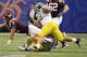 NEW ORLEANS, LA - JANUARY 03: Logan Thomas #3 of the Virginia Tech Hokies attempts to reach for extra yardage as he is tackeled by Ryan Van Bergen #53 and Mike Martin #68 of the Michigan Wolverines during the Allstate Sugar Bowl at Mercedes-Benz Superdome on January 3, 2012 in New Orleans, Louisiana. (Photo by Matthew Stockman/Getty Images)