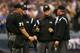 MILWAUKEE - OCTOBER 04: Umpire Crew chief Dana DeMuth #22 (2nd R) huddles with his crew to discuss a interference by Shane Victorino #8 of the Philadelphia Philles against Craig Counsell #30 of the Milwaukee Brewers in the top of the ninth inning of Game three of the NLDS during the 2008 MLB playoffs at Miller Park on October 4, 2008 in Milwaukee, Wisconsin. (Photo by Jim McIsaac/Getty Images)