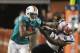 MIAMI GARDENS, FL - SEPTEMBER 12: Reciever Brandon Marshall#19 of the Miami Dolphins stiff arms Linebacker Dane Fletcher #51 of the New England Patriots at Sun Life Stadium on September 12, 2011 in Miami Gardens, Florida. (Photo by Marc Serota/Getty Images)