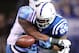 INDIANAPOLIS, IN - DECEMBER 18: Pierre Garcon #85 of the Indianapolis Colts runs with the ball and fumbles as he is tackled by Akeem Ayers #56 of the Tennessee Titans during Colts 27-13 win in the NFL game at Lucas Oil Stadium on December 18, 2011 in Indianapolis, Indiana. (Photo by Andy Lyons/Getty Images)