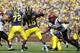 ANN ARBOR, MI - SEPTEMBER 24: Denard Robinson #16 of the Michigan Wolverines drops back to pass as Jerome Long #94 and J. J. Autele #49 of San Diego State rush during the game at Michigan Stadium on September 24, 2011 in Ann Arbor, Michigan. Michigan defeated San Diego 28-7. (Photo by Leon Halip/Getty Images)