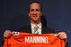 ENGLEWOOD, CO - MARCH 20: Quarterback Peyton Manning poses with his uniform after the news conference announcing his contract with the Denver Broncos in the team meeting room at the Paul D. Bowlen Memorial Broncos Centre on March 20, 2012 in Englewood, Colorado. Manning, entering his 15th NFL season, was released by the Indianapolis Colts on March 7, 2012, where he had played his whole career. It has been reported that Manning will sign a five-year, $96 million offer. (Photo by Doug Pensinger/Getty Images)