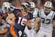 DENVER, CO - NOVEMBER 17: Quarterback Tim Tebow #15 of the Denver Broncos rushes against Eric Smith #33 of the New York Jets at Sports Authority Field at Mile High on November 17, 2011 in Denver, Colorado. The Broncos defeated the Jets 17-13. (Photo by Doug Pensinger/Getty Images)