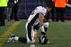 FOXBORO, MA - JANUARY 14: Tim Tebow #15 of the Denver Broncos kneels on the sideline in the second half against the New England Patriots during their AFC Divisional Playoff Game at Gillette Stadium on January 14, 2012 in Foxboro, Massachusetts. (Photo by Jim Rogash/Getty Images)