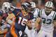 DENVER, CO - NOVEMBER 17: Quarterback Tim Tebow #15 of the Denver Broncos rushes against Eric Smith #33 of the New York Jets at Sports Authority Field at Mile High on November 17, 2011 in Denver, Colorado. The Broncos defeated the Jets 17-13. (Photo by Doug Pensinger/Getty Images)