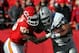 KANSAS CITY, MO - DECEMBER 24: Justin Houston #50 of the Kansas City Chiefs tackles Michael Bush #29 of the Oakland Raiders as Bush carries the ball upfield during the game on December 24, 2011 at Arrowhead Stadium in Kansas City, Missouri. (Photo by Jamie Squire/Getty Images)