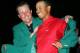 AUGUSTA, GA - APRIL 10: Tiger Woods smiles as he is presented with the green jacket by Phil Mickelson after Woods won The Masters at the Augusta National Golf Club on April 10, 2005 in Augusta, Georgia. (Photo by Harry How/Getty Images)