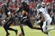 CINCINNATI, OH - DECEMBER 03: Munchie Legaux #4 of the Cincinnati Bearcats runs from Byron Jones #16 of the Connecticut Huskies on December 3, 2011 at Nippert Stadium in Cincinnati, Ohio. The Bearcats defeated the Connecticut Huskies 35-27. (Photo by Tyler Barrick/Getty Images)