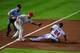 ATLANTA - SEPTEMBER 28: Placido Polanco #27 of the Philadelphia Phillies tags out Michael Bourn #24 on a steal attempt the Atlanta Braves at Turner Field on September 28, 2011 in Atlanta, Georgia. (Photo by Scott Cunningham/Getty Images)