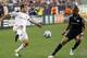 FOXBORO, MA - MAY 28: Landon Donovan #10 of the Los Angeles Galaxy passes around Darrius Barnes #25 of the New England Revolution on May 28, 2011 at Gillette Stadium in Foxboro, Massachusetts. The Los Angeles Galaxy defeated the New England Revolution 1-0. (Photo by Elsa/Getty Images)