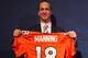 ENGLEWOOD, CO - MARCH 20: Quarterback Peyton Manning poses with his uniform after the news conference announcing his contract with the Denver Broncos in the team meeting room at the Paul D. Bowlen Memorial Broncos Centre on March 20, 2012 in Englewood, Colorado. Manning, entering his 15th NFL season, was released by the Indianapolis Colts on March 7, 2012, where he had played his whole career. It has been reported that Manning will sign a five-year, $96 million offer. (Photo by Doug Pensinger/Getty Images)