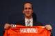 ENGLEWOOD, CO - MARCH 20: Quarterback Peyton Manning poses with his uniform after the news conference announcing his contract with the Denver Broncos in the team meeting room at the Paul D. Bowlen Memorial Broncos Centre on March 20, 2012 in Englewood, Colorado. Manning, entering his 15th NFL season, was released by the Indianapolis Colts on March 7, 2012, where he had played his whole career. It has been reported that Manning will sign a five-year, $96 million offer. (Photo by Doug Pensinger/Getty Images)