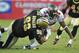 TAMPA, FL - OCTOBER 16: Defensive tackle Shaun Rogers #92 of the New Orleans Saints tackles running back Earnest Graham #34 of the Tampa Bay Buccaneers October 16, 2011 at Raymond James Stadium in Tampa, Florida. (Photo by Al Messerschmidt/Getty Images)