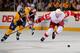 NASHVILLE, TN - MARCH 10: Brad Stuart #23 of the Detroit Red Wings and Matt Halischuk #24 of the Nashville Predators chase the puck at the Bridgestone Arena on March 10, 2012 in Nashville, Tennessee. (Photo by Frederick Breedon/Getty Images)