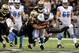 NEW ORLEANS, LA - JANUARY 07: Jonathan Vilma #51 of the New Orleans Saints tries to tackle Kevin Smith #30 of the Detroit Lions during their 2012 NFC Wild Card Playoff game at Mercedes-Benz Superdome on January 7, 2012 in New Orleans, Louisiana. (Photo by Kevin C. Cox/Getty Images)