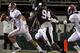 STARKVILLE, MS - NOVEMBER 12: quarterback AJ McCarron #10 of the Alabama Crimson Tide scrambles away from pressure from defensive lineman Fletcher Cox #94 of the Mississippi State Bulldogs on November 12, 2011 at Davis Wade Stadium in Starkville, Mississippi. Alabama won 24-7. (Photo by Butch Dill/Getty Images)
