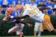 GAINESVILLE, FL - SEPTEMBER 17: Running back Chris Rainey #1 of the Florida Gators has his facemask grabbed by defensive lineman Malik Jackson #97 of the Tennessee Volunteers during a game at Ben Hill Griffin Stadium on September 17, 2011 in Gainesville, Florida. (Photo by Sam Greenwood/Getty Images)
