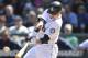 SEATTLE, WA - APRIL 15: Justin Smoak of the Seattle Mariners hits a solo homer in the third inning against the Oakland Athletics at Safeco Field on April 15, 2012 in Seattle, Washington. In honor of Jackie Robinson Day, all players across Major League Baseball will wear number 42. (Photo by Otto Greule Jr/Getty Images)