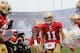 SAN FRANCISCO, CA - JANUARY 22: Alex Smith #11 of the San Francisco 49ers greets his teammates as he takes the field against the New York Giants during the NFC Championship Game at Candlestick Park on January 22, 2012 in San Francisco, California. (Photo by Thearon W. Henderson/Getty Images)