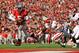 COLUMBUS, OH - NOVEMBER 5: Quarterback Braxton Miller #5 of the Ohio State Buckeyes scores the second of his two touchdowns against Indiana in the second half as Ryan Phillis #25 of the Indiana Hoosiers and Alexander Webb #27 of the Indiana Hoosiers give chase at Ohio Stadium on November 5, 2011 in Columbus, Ohio. Ohio State defeated Indiana 34-20. (Photo by Jamie Sabau/Getty Images)