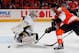 PHILADELPHIA, PA - APRIL 22: Goalie Marc-Andre Fleury #29 of the Pittsburgh Penguins just gets his stick on the puck to make a save on Claude Giroux #28 of the Philadelphia Flyers in the second period of Game Six of the Eastern Conference Quarterfinals during the 2012 NHL Stanley Cup Playoffs at Wells Fargo Center on April 22, 2012 in Philadelphia, Pennsylvania. (Photo by Paul Bereswill/Getty Images)