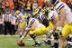 NEW ORLEANS, LA - JANUARY 03: Offensive center David Molk #50 of the Michigan Wolverines readies for the snap at the line of scrimmage against the Virginia Tech Hokies during the Allstate Sugar Bowl at Mercedes-Benz Superdome on January 3, 2012 in New Orleans, Louisiana. (Photo by Kevin C. Cox/Getty Images)