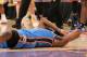 James Harden laying on court after being elbowed in the temple by Metta World Peace.