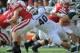 LINCOLN, NE - OCTOBER 29: Linebacker Max Bullough #40 of the Michigan State Spartans reaches for running back Rex Burkhead #22 of the Nebraska Cornhuskers during their game at Memorial Stadium October 29, 2011 in Lincoln, Nebraska. Nebraska defeated Michigan State 24-3. (Photo by Eric Francis/Getty Images)
