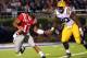 OXFORD, MS - NOVEMBER 19: Barry Brunetti #11 of the Ole Miss Rebels scrambles with the ball against Michael Brockers #90 of the LSU Tigers on November 19, 2011 at Vaught-Hemingway Stadium in Oxford, Mississippi. (Photo by Joe Murphy/Getty Images)