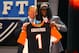 NEW YORK, NY - APRIL 26: Dre Kirkpatrick (R) of Alabama holds up a jersey as he stands on stage with NFL Commissioner Roger Goodell after he was selected #17 overall by the Cincinnati Bengals in the first round of during the 2012 NFL Draft at Radio City Music Hall on April 26, 2012 in New York City. (Photo by Al Bello/Getty Images)