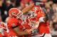 ATHENS, GA - NOVEMBER 27: Cordy Glenn #71 and Ben Jones #61 of the Georgia Bulldogs celebrate with Orson Charles #7 after Charles touchdown against the Georgia Tech Yellow Jackets at Sanford Stadium on November 27, 2010 in Athens, Georgia. (Photo by Kevin C. Cox/Getty Images)