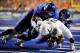 BOISE, ID - SEPTEMBER 3: LaMichael James #21 of the Oregon Ducks is is gang tackled by George Iloka #8 of Boise State Broncos and others in the third quarter of the game on September 3, 2009 at Bronco Stadium in Boise, Idaho. Boise State won the game 19-8. (Photo by Steve Dykes/Getty Images)