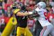 IOWA CITY, IA - NOVEMBER 20: Quarterback Ricky Stanzi #12 of the University of Iowa Hawkeyes throws under pressure from defensive lineman Solomon Thomas #98 of the Ohio State Buckeyes as offensive lineman Riley Reiff #77 defends during the first half of play at Kinnick Stadium on November 20, 2010 in Iowa City, Iowa. Ohio State won 20-17 over Iowa. (Photo by David Purdy/Getty Images)