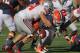 CHAMPAIGN, IL - OCTOBER 15: Jason Ford #21 of the Illinois Fighting Illini moves to recover his own fumble as he is hit by John Simon #54 of the Ohio State Buckeyes at Memorial Stadium on October 15, 2011 in Champaign, Illinois. Ohio State defeated Illinois 17-7. (Photo by Jonathan Daniel/Getty Images)