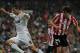 MADRID, SPAIN - MAY 08: Cristiano Ronaldo (L) of Real Madrid jumps over goalkeeper Gorka Iraizoz and past Javi Martinez (R) of Athletic Bilbao during the La Liga match between Real Madrid and Athletic Bilbao at the Estadio Santiago Bernabeu on May 8, 2010 in Madrid, Spain. Real Madrid won the match 5-1. (Photo by Jasper Juinen/Getty Images)