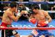 LAS VEGAS, NV - NOVEMBER 12: Juan Manuel Marquez (L) hits Manny Pacquiao in the 11th round of their WBO world welterweight title fight at the MGM Grand Garden Arena November 12, 2011 in Las Vegas, Nevada. Pacquiao retained his title with a majority decision victory. (Photo by Ethan Miller/Getty Images)