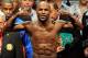 LAS VEGAS, NV - MAY 04: Boxer Floyd Mayweather Jr. poses on the scale during the official weigh-in for his bout against WBA super welterweight champion Miguel Cotto at the MGM Grand Garden Arena on May 4, 2012 in Las Vegas, Nevada. Mayweather will challenge Cotto for his title on May 5, 2012 in Las Vegas. (Photo by Ethan Miller/Getty Images)