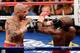 LAS VEGAS, NV - MAY 05: Miguel Cotto (L) hits Floyd Mayweather Jr. during the 12th round of their WBA super welterweight title fight at the MGM Grand Garden Arena May 5, 2012 in Las Vegas, Nevada. Mayweather won by unanimous decision. (Photo by Ethan Miller/Getty Images)