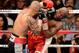 LAS VEGAS, NV - MAY 05: Miguel Cotto (L) hits Floyd Mayweather Jr. during the ninth round of their WBA super welterweight title fight at the MGM Grand Garden Arena May 5, 2012 in Las Vegas, Nevada. Mayweather won by unanimous decision. (Photo by Ethan Miller/Getty Images)