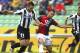 Udinese defender Giovanni Pasquale tussles with Genoa defender Giandomenico Mesto
