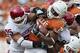 DALLAS, TX - OCTOBER 8: Malcolm Brown #28 of the Texas Longhorns is tackled by the defense of the Oklahoma Sooners at the Cotton Bowl on October 8, 2011 in Dallas, Texas. The Sooners defeated the Longhorns 55 to 17. (Photo by Wesley Hitt/Getty Images)