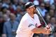 BOSTON, MA - APRIL 13: Kevin Youkilis #20 of the Boston Red Sox hits a sacrifice fly to score a run in the third inning against the Tampa Bay Rays during the home opener on April 13, 2012 at Fenway Park in Boston, Massachusetts. (Photo by Elsa/Getty Images)
