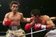 LAS VEGAS - NOVEMBER 18: (L-R) Brian Viloria throws a left hook at Omar Nino of Mexico after taking a punch during their light flyweight bout at the Thomas & Mack Center on November 18, 2006 in Las Vegas, Nevada. (Photo by Jed Jacobsohn/Getty Images)