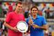 MADRID, SPAIN - MAY 13: Tomas Berdych of Czech Republic holds the runners up plate as Roger Federer of Switzerland holds the winner's trophy after the Men's Single Final on Day Nine of the Mutua Madrilena Madrid Open at the Caja Magica on May 13, 2012 in Madrid, Spain. (Photo by Mike Hewitt/Getty Images)