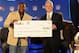 INDIANAPOLIS, IN - FEBRUARY 01: Buzzy Thiboduaux, EVP of Junior Achievement, (right) presents a check to NFL Running Back LeSean McCoy of the Philadelphia Eagles, the 2011 FedEx Ground NFL Player of the year during the FedEx Air and Ground NFL Players of the Year awards during a news conference prior to Super Bowl XLVI. In honor of the winners' great seasons, FedEx will donate $25,000 to each of their local New Orleans and Philadelphia Junior Achievement chapters to support the next generation of entrepreneurs in their communities. at JW Marriott on February 1, 2012 in Indianapolis, Indiana. (Photo by Rick Diamond/Getty Images for FedEx,)