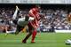 LONDON, ENGLAND - SEPTEMBER 18: Kyle Walker of Tottenham Hotspur is challenged by Jose Enrique of Liverpool during the Barclays Premier League match between Tottenham Hotspur and Liverpool at White Hart Lane on September 18, 2011 in London, England. (Photo by Clive Rose/Getty Images)